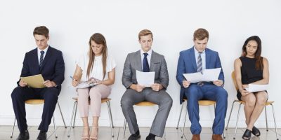 Candidates waiting for job interviews, full length, front