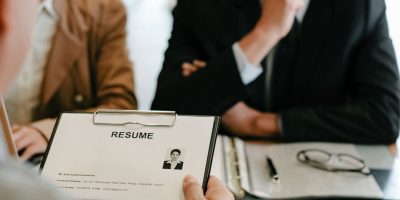 Examiner reading a resume during job interview at office Business and human resources concept.